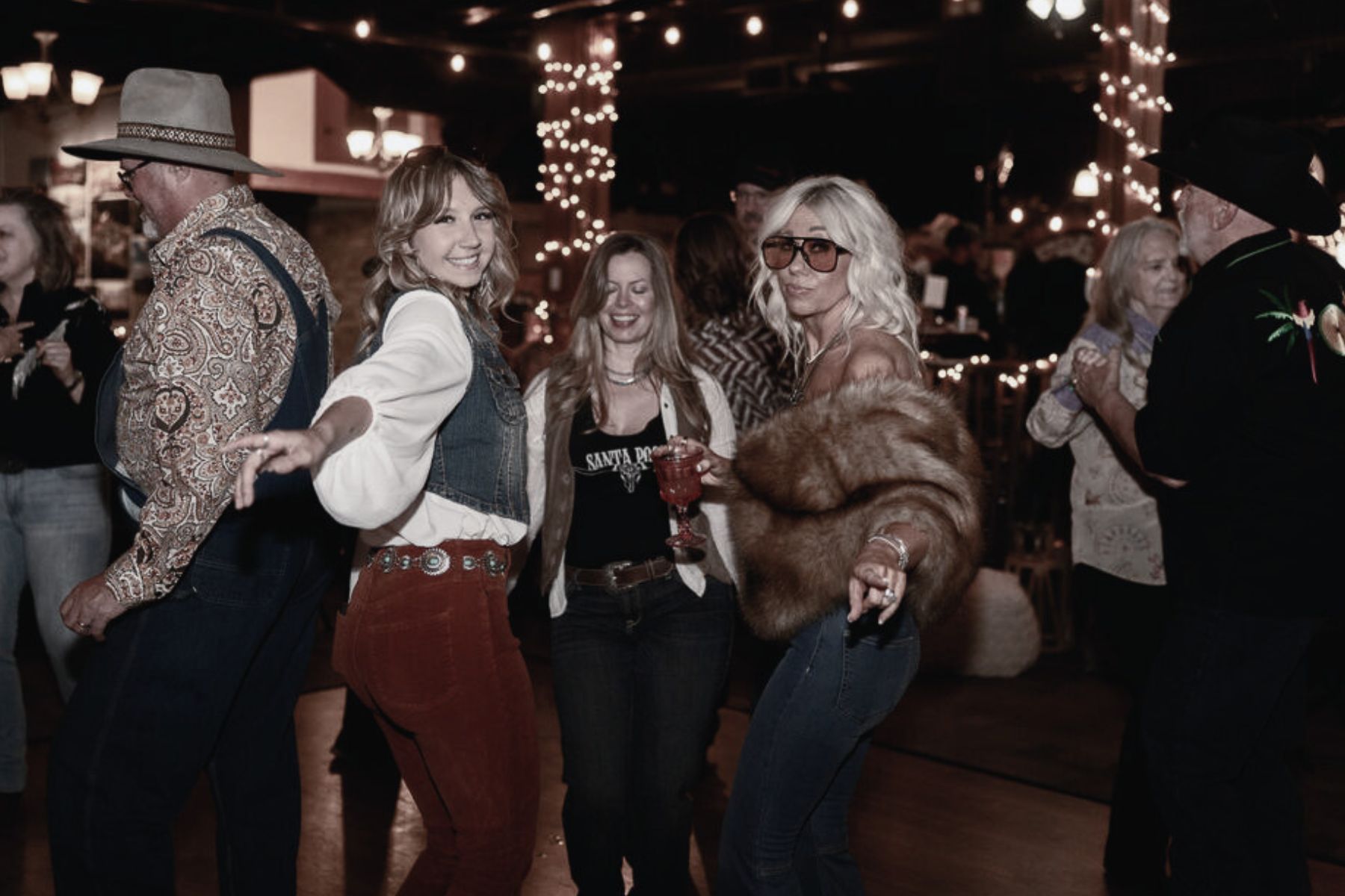 Disco Cowgirl themed 50th birthday party decor with neon signs and retro styling