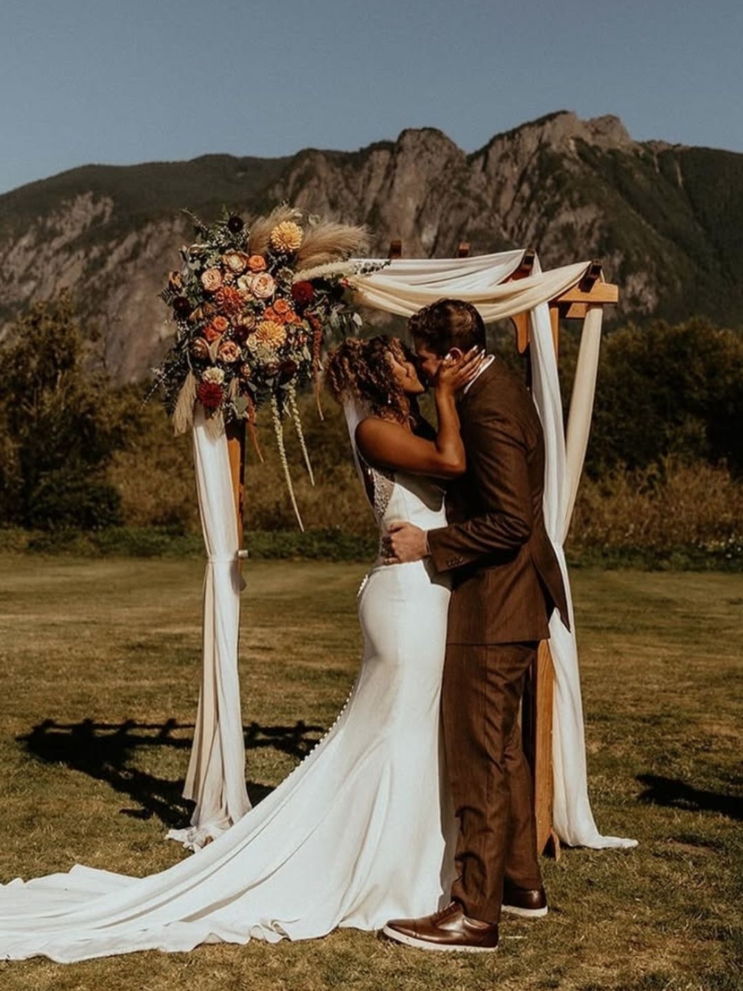 Outdoor boho wedding ceremony with mountain views by Vibe Events