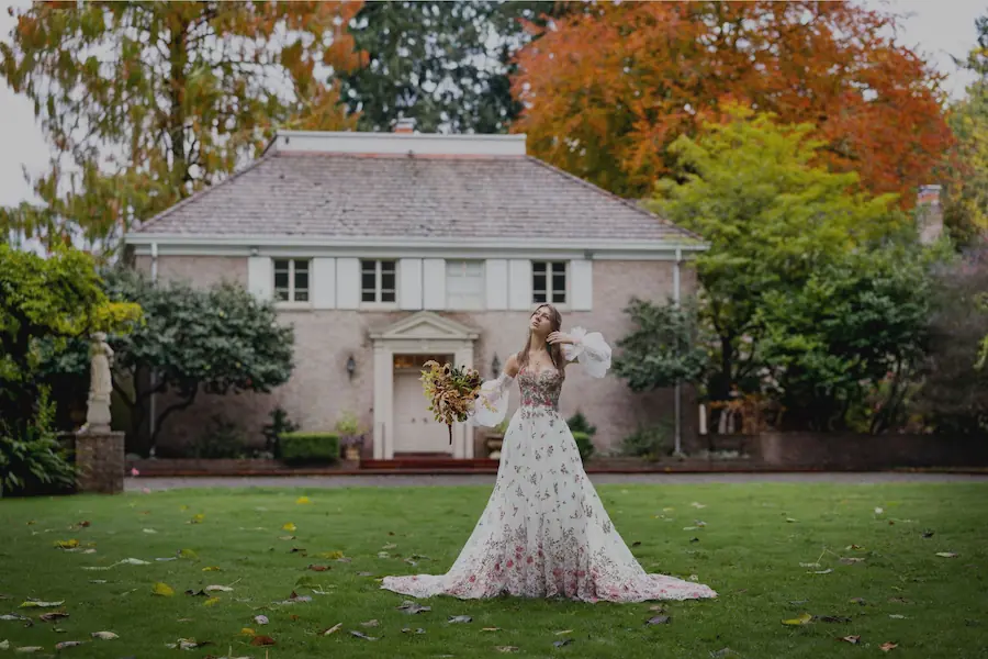 enchanted bride in the gardens standing in front of a manor
