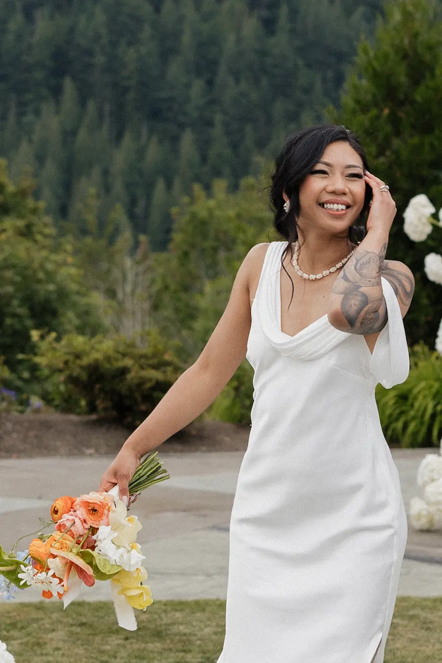 Pacific Northwest outdoor wedding setup surrounded by lush ferns and evergreen trees